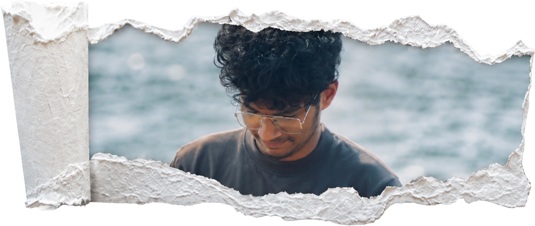 Sreedev framed by a torn-paper collage